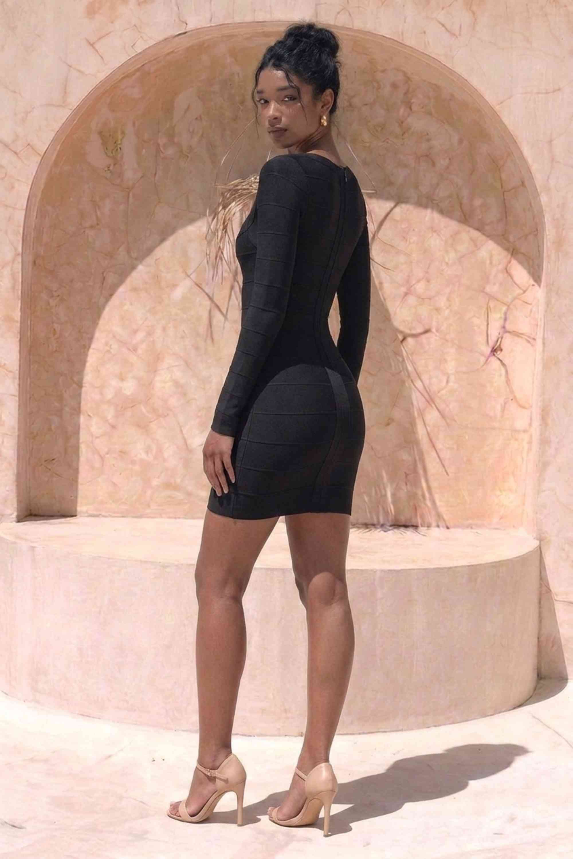 Woman wearing a figure flattering Valentina Long Sleeve Bandage Mini Dress - Classic Black BODYCON COLLECTION Pty Ltd