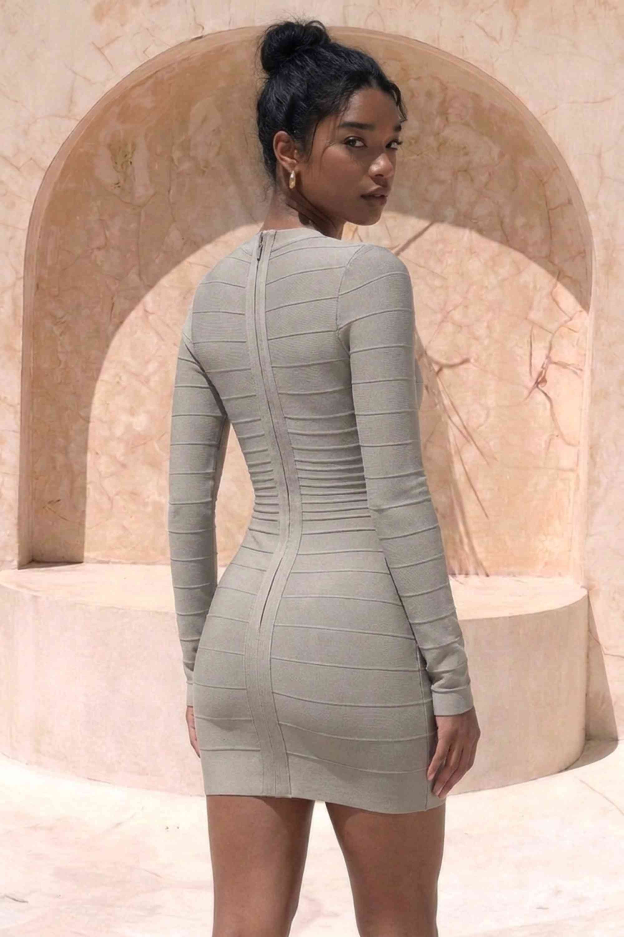 Woman wearing a figure flattering Valentina Long Sleeve Bandage Mini Dress - Oyster Grey BODYCON COLLECTION Pty Ltd