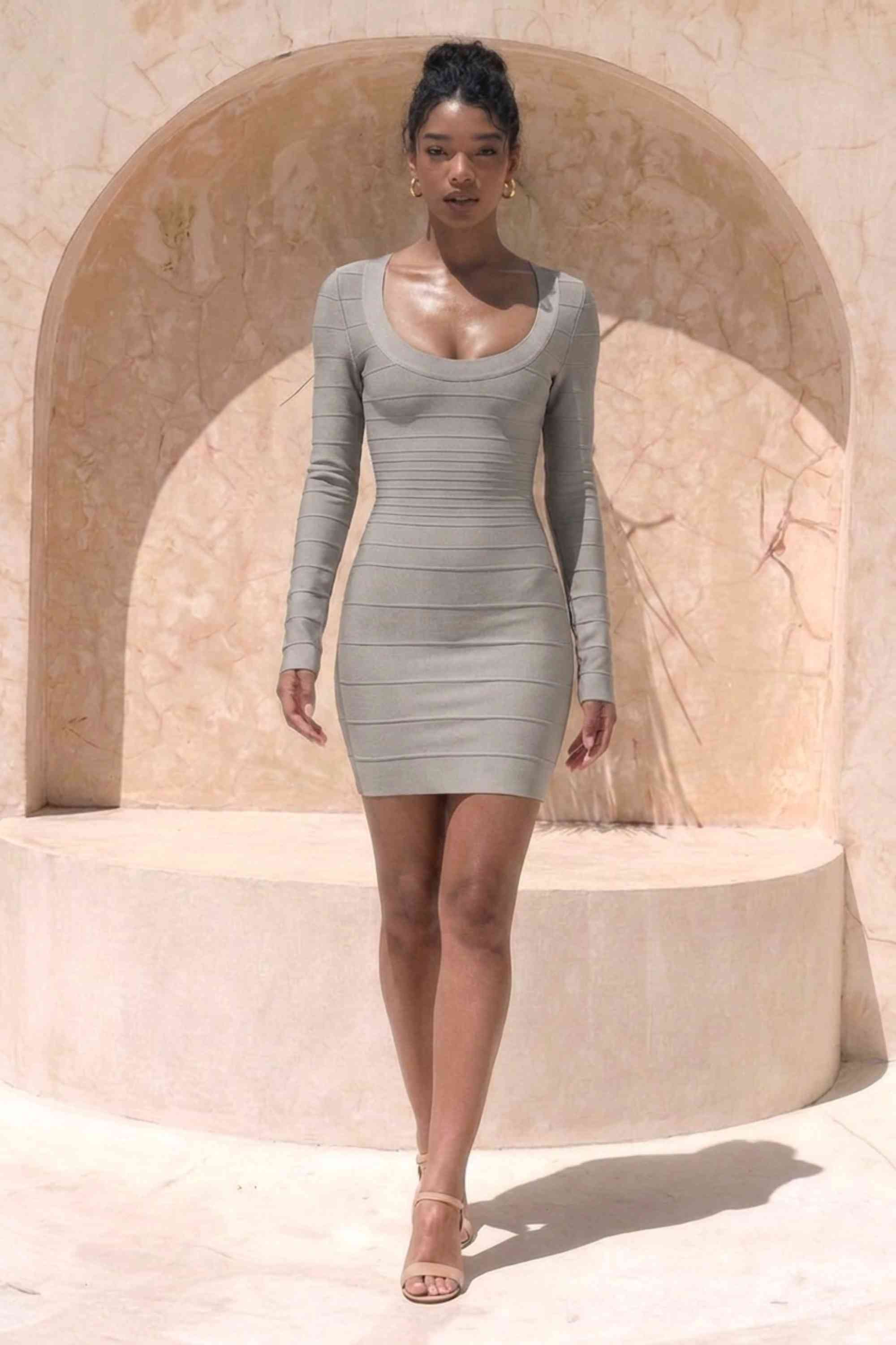 Woman wearing a figure flattering Valentina Long Sleeve Bandage Mini Dress - Oyster Grey BODYCON COLLECTION Pty Ltd