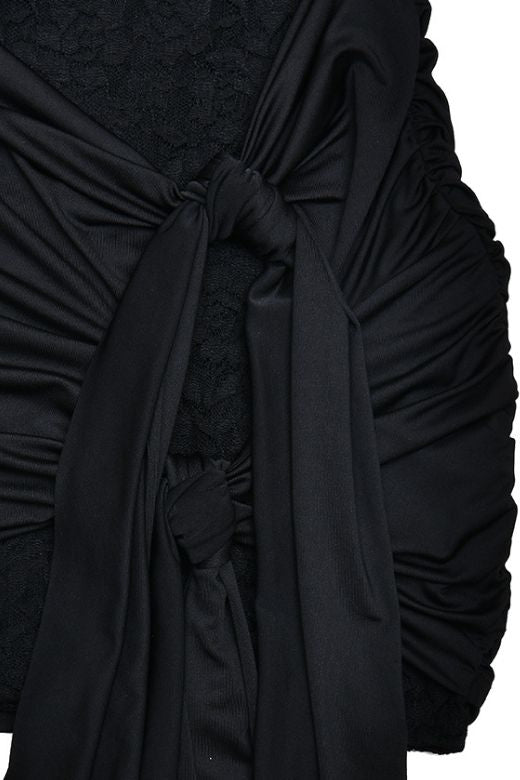 Woman wearing a figure flattering Vera Long Sleeve Bodycon Wrap Mini Dress - Classic Black BODYCON COLLECTION