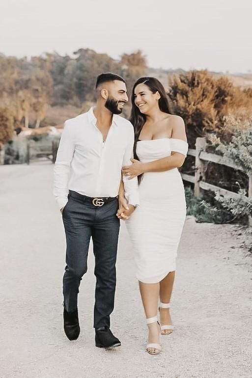 Woman wearing a figure flattering  Zia Bodycon Wrap Midi Dress - Pearl White Bodycon Collection