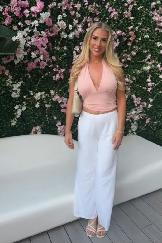 Woman wearing a figure flattering  Aby Halter Top - Pink Peach Fuzz BODYCON COLLECTION Pty Ltd