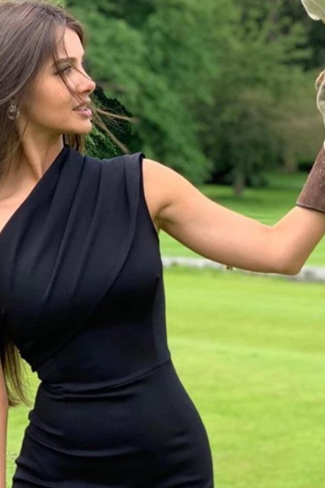 Woman wearing a figure flattering  Ally Bodycon Midi Dress - Classic Black Bodycon Collection