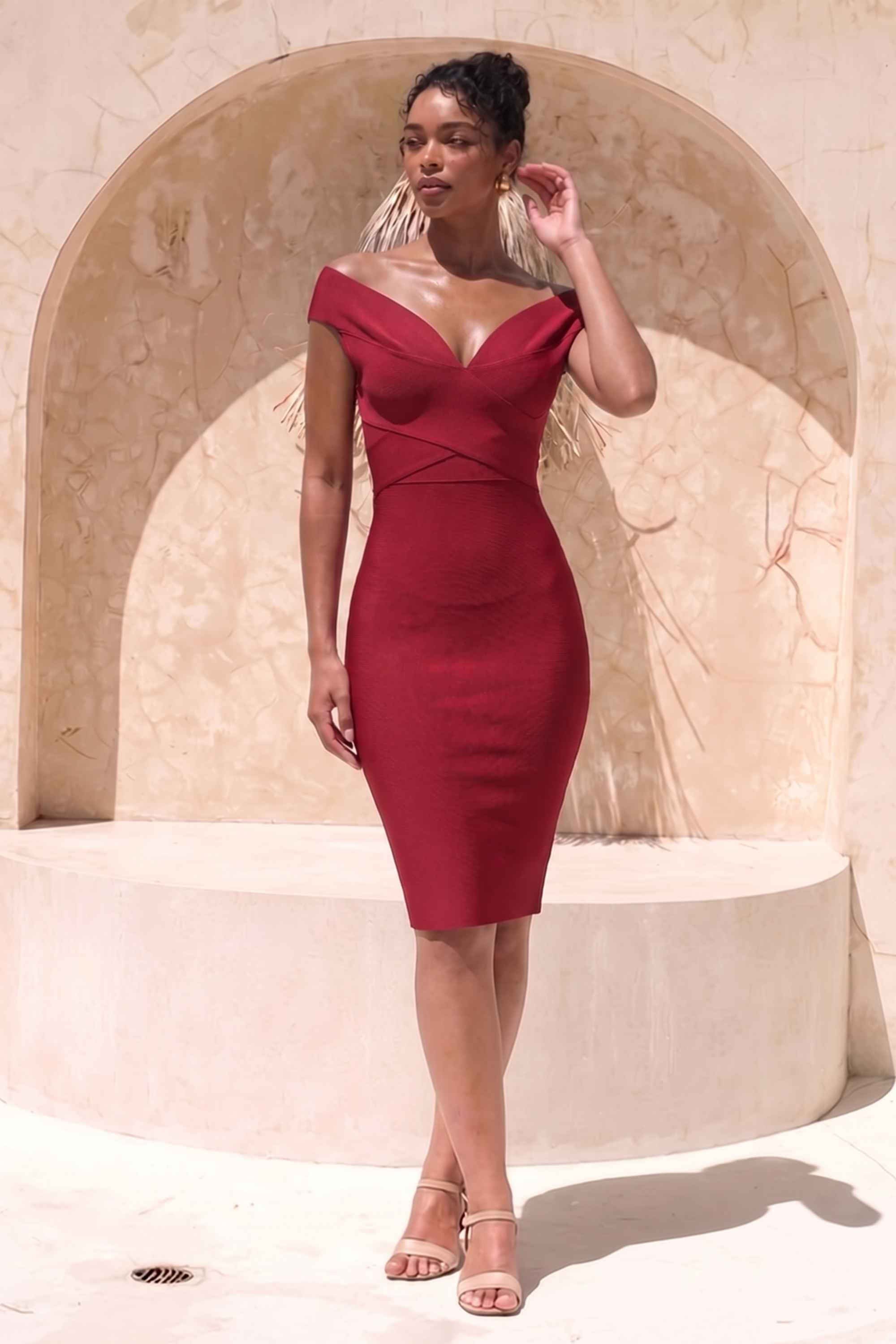 Woman wearing a figure flattering  Ash Bandage Dress - Red Wine Bodycon Collection