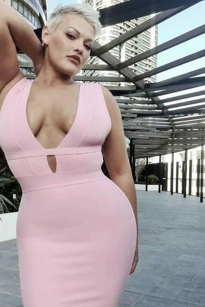 Woman wearing a figure flattering  Bay Bandage Dress - Blush Pink Bodycon Collection
