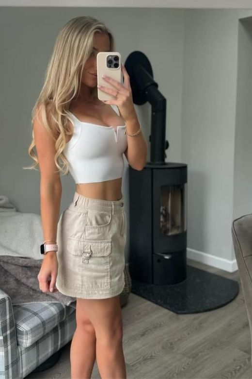 Woman wearing a figure flattering  Brooke Bandage Crop Top - Pearl White BODYCON COLLECTION