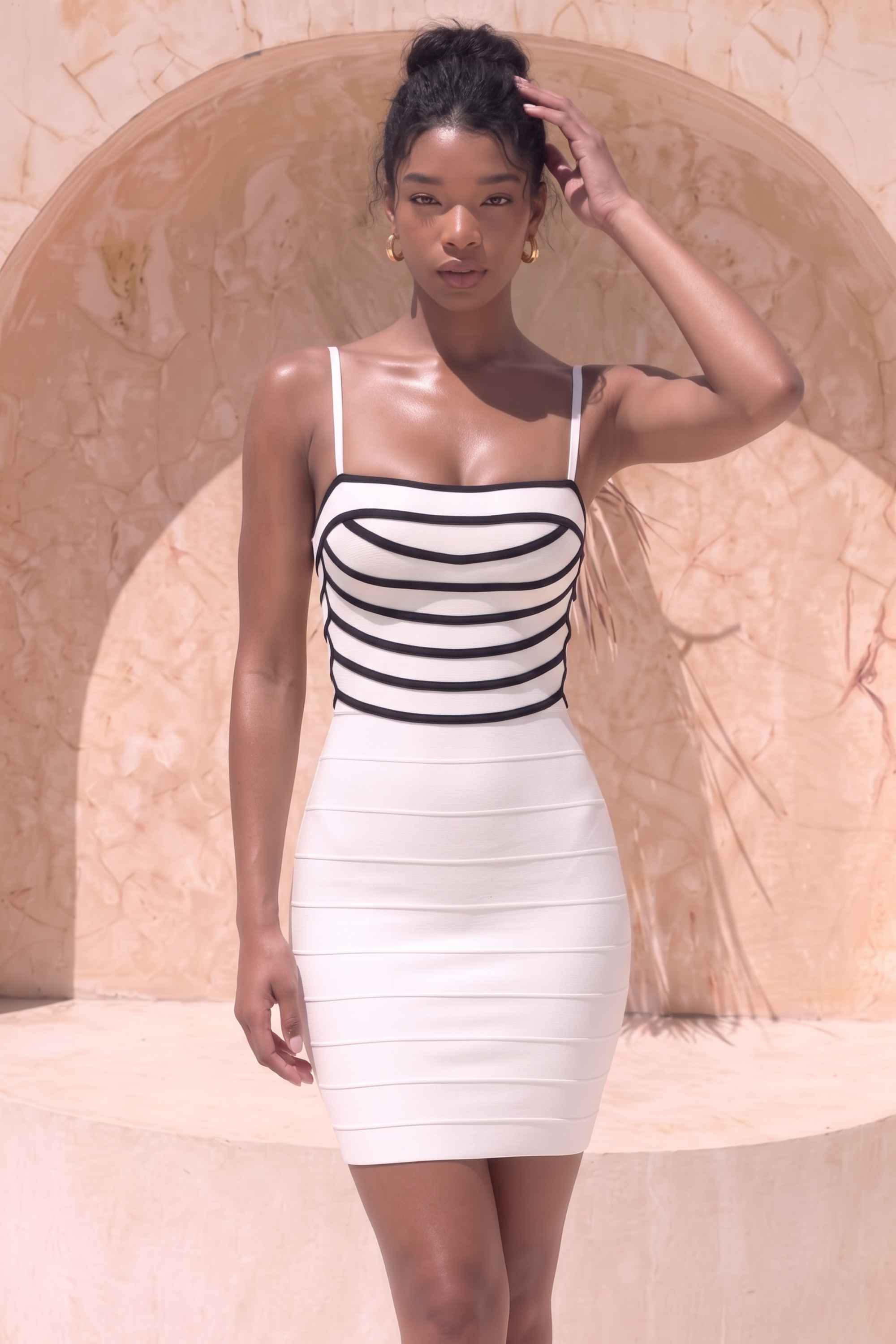 Woman wearing a figure flattering  Carter Bandage Mini Dress - White Pearl BODYCON COLLECTION