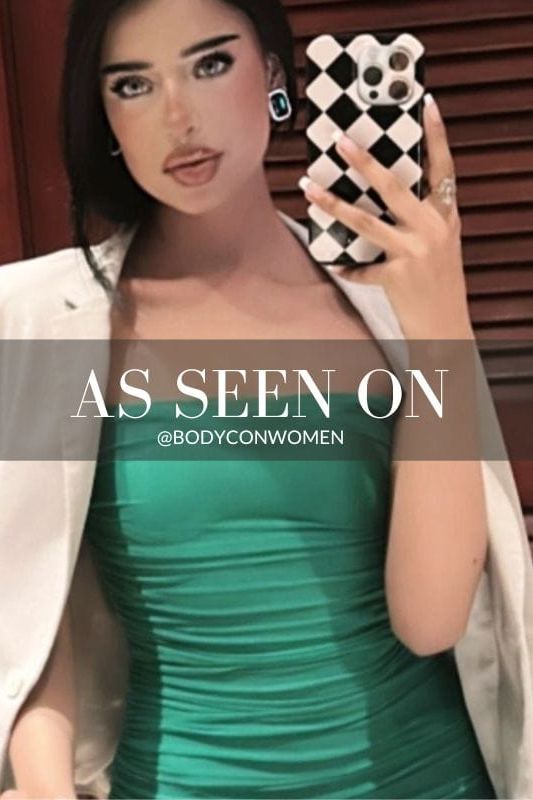 Woman wearing a figure flattering  Cassie Bodycon Wrap Mini Dress - Emerald Green BODYCON COLLECTION