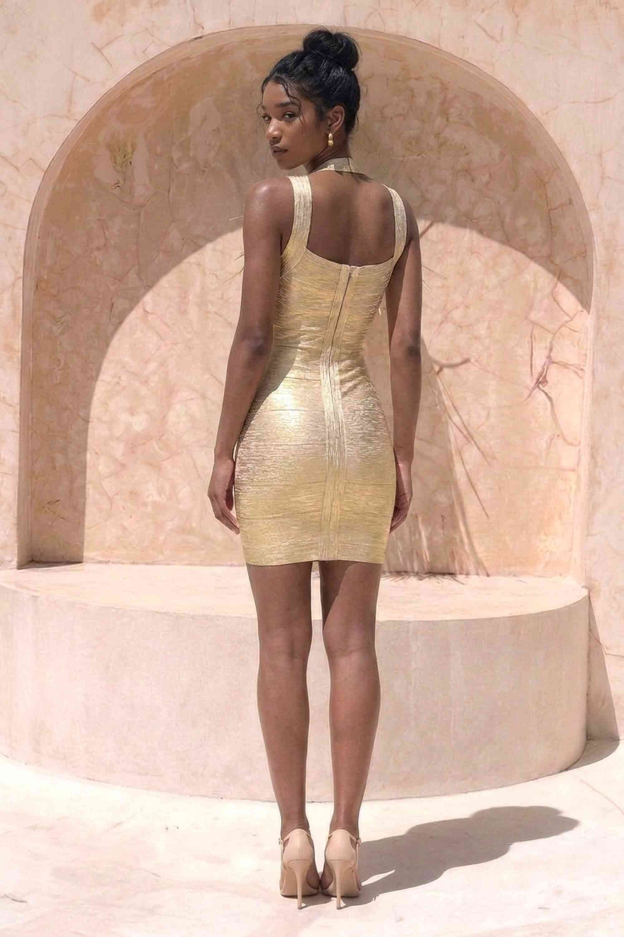Woman wearing a figure flattering  Ciara Bandage Mini Dress - Gold BODYCON COLLECTION