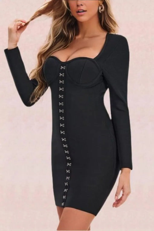 Woman wearing a figure flattering  Dani Long Sleeve Mini Bandage Dress - Classic Black BODYCON COLLECTION