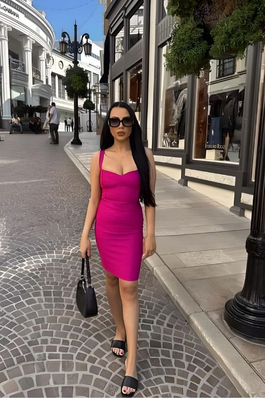 Woman wearing a figure flattering  Heidi Bandage Mini Dress - Magenta Pink Bodycon Collection