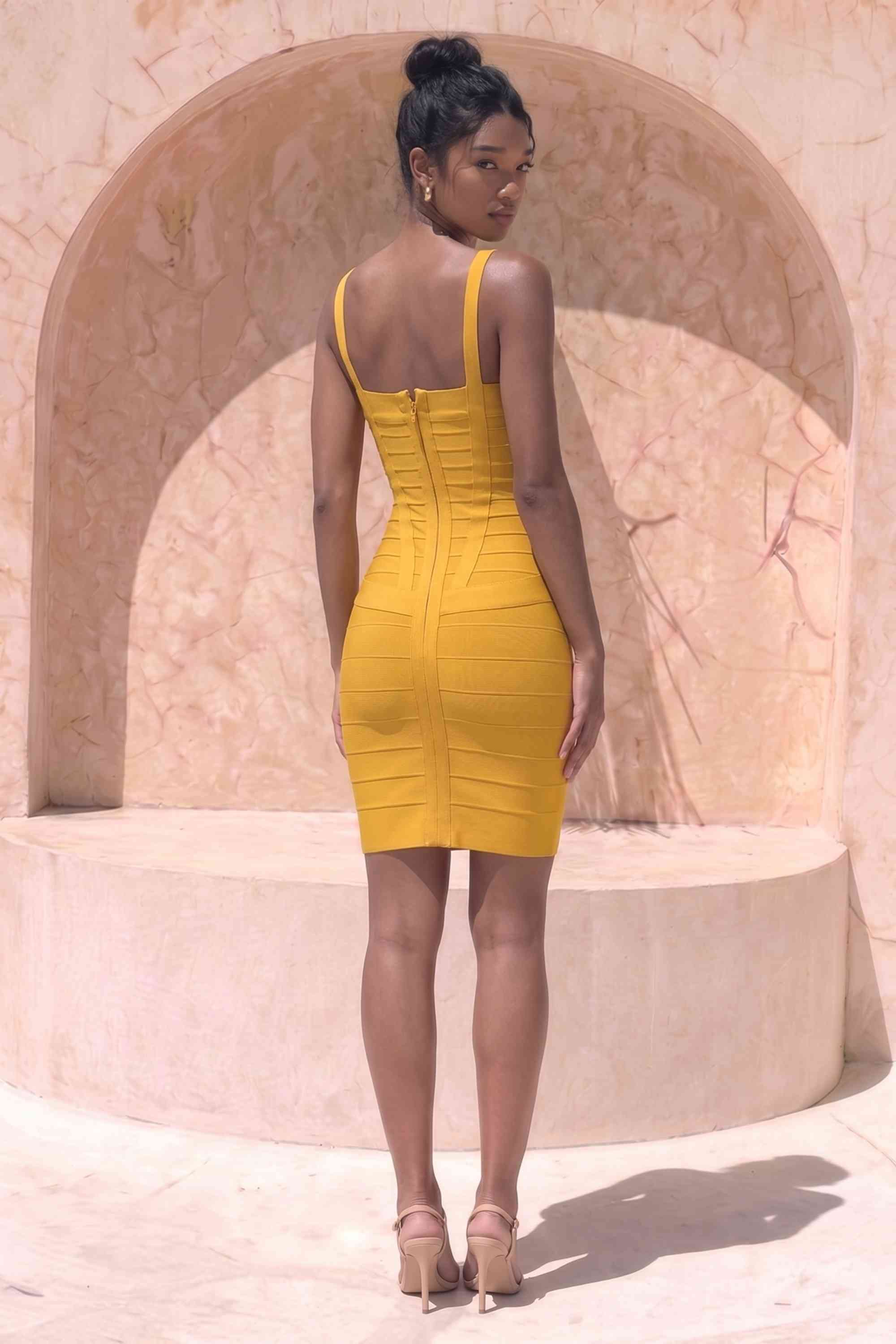 Woman wearing a figure flattering  Heidi Bandage Mini Dress - Mustard Yellow Bodycon Collection