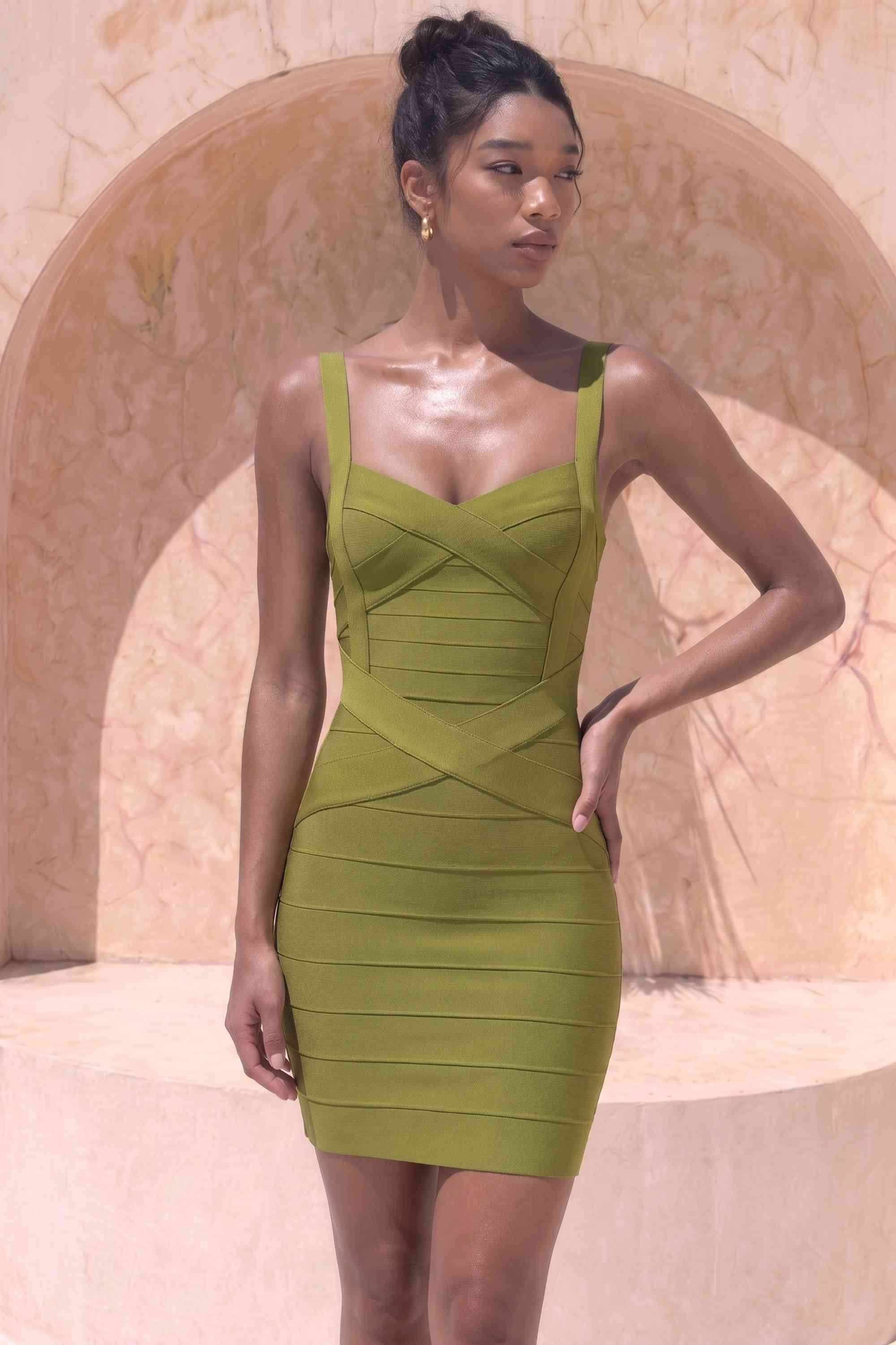 Woman wearing a figure flattering  Heidi Bandage Mini Dress - Olive Green Bodycon Collection