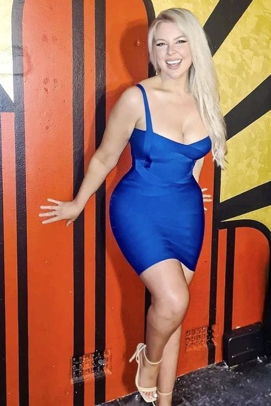 Woman wearing a figure flattering  Heidi Bandage Mini Dress - Royal Blue Bodycon Collection