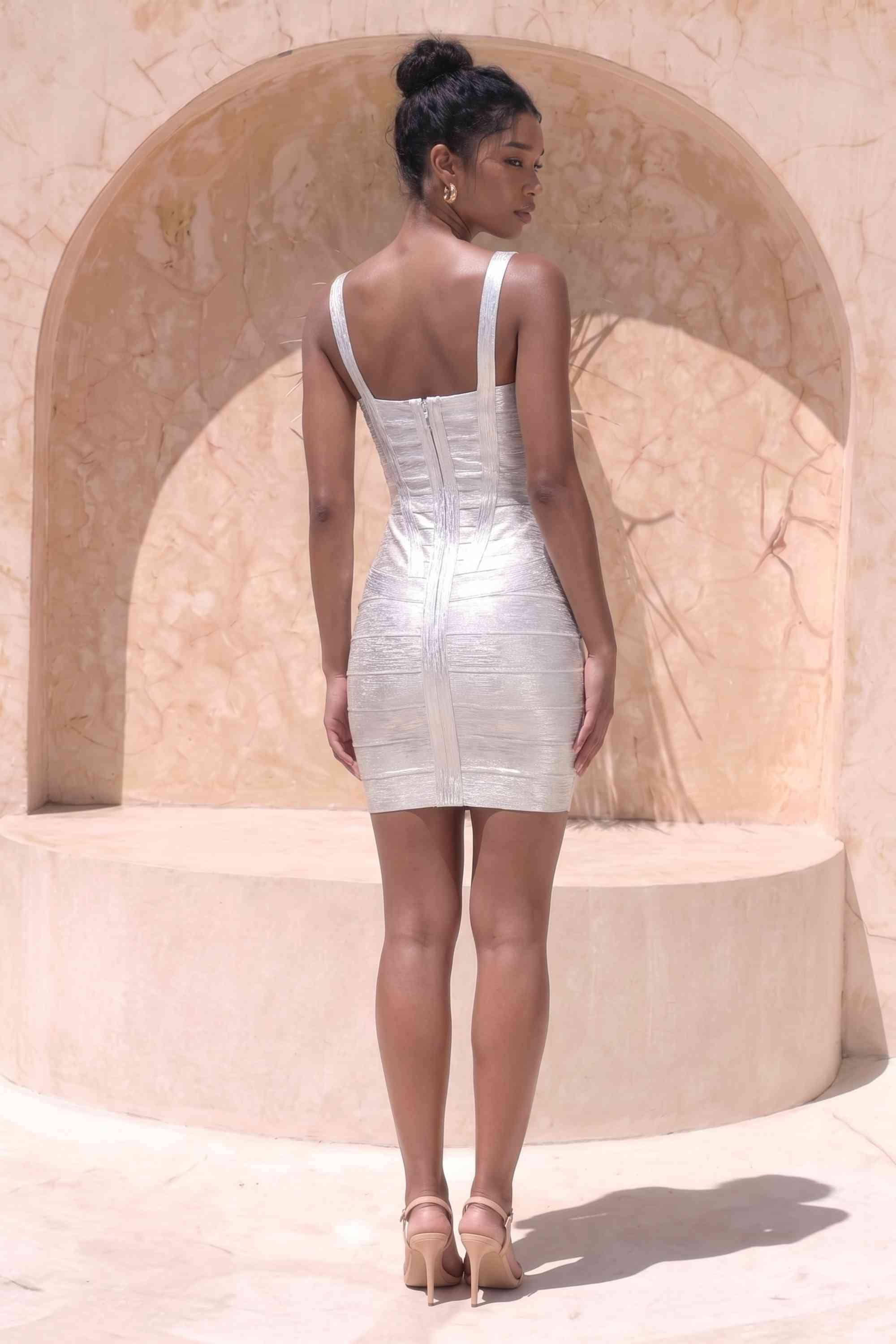 Woman wearing a figure flattering  Heidi Bandage Mini Dress - Silver Bodycon Collection