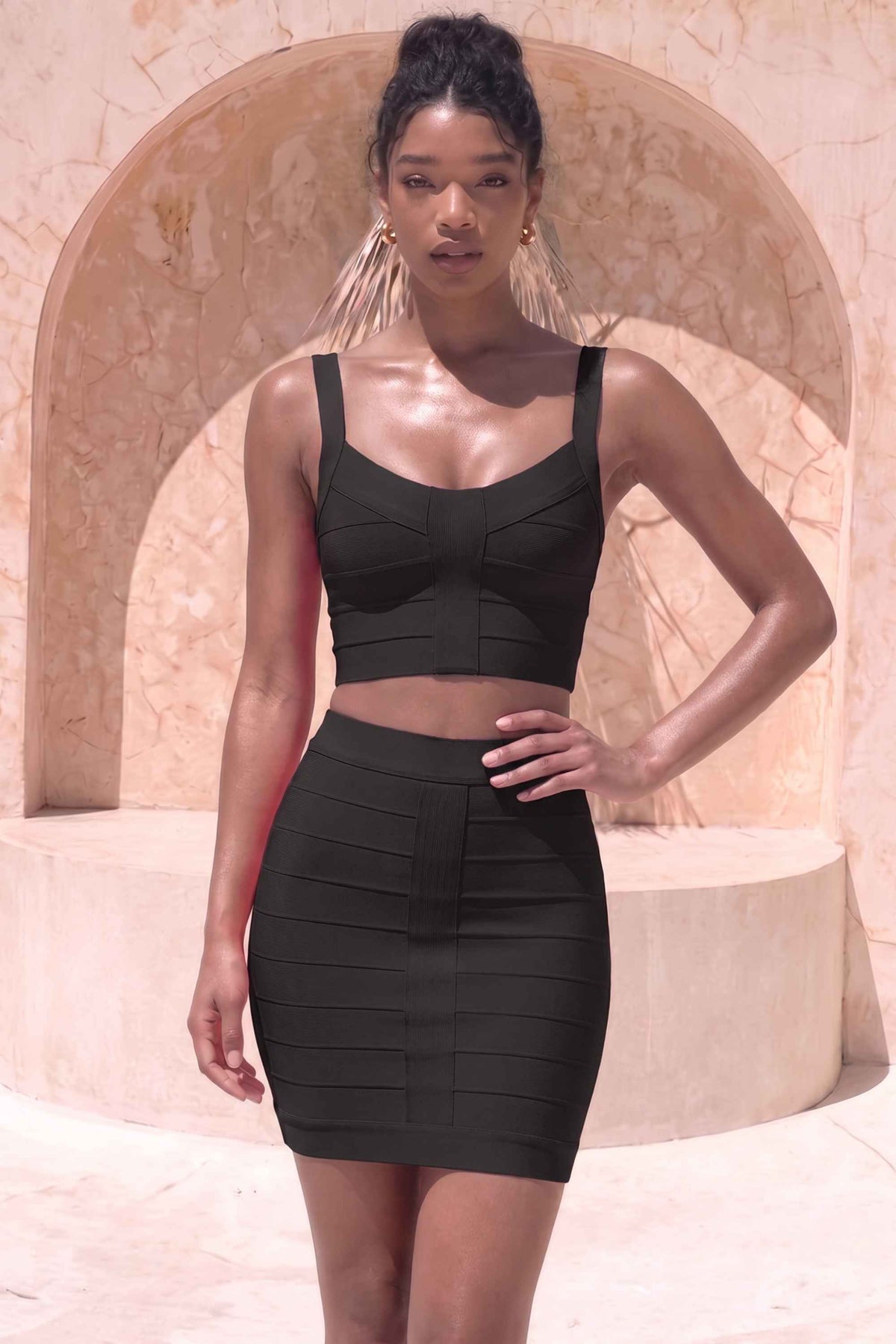 Woman wearing a figure flattering  India Bandage Top and Mini Skirt Outfit Set - Classic Black BODYCON COLLECTION