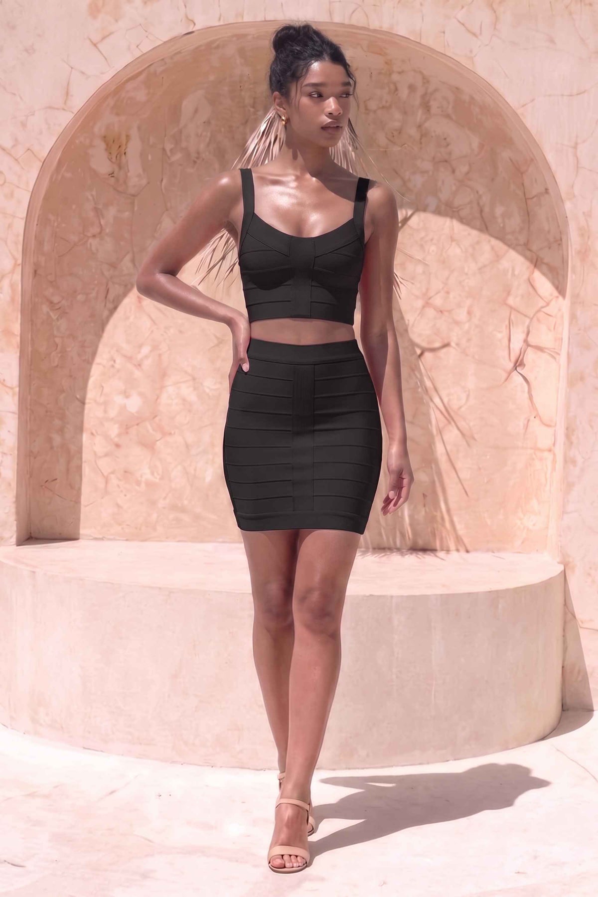 Woman wearing a figure flattering  India Bandage Top and Mini Skirt Outfit Set - Classic Black BODYCON COLLECTION