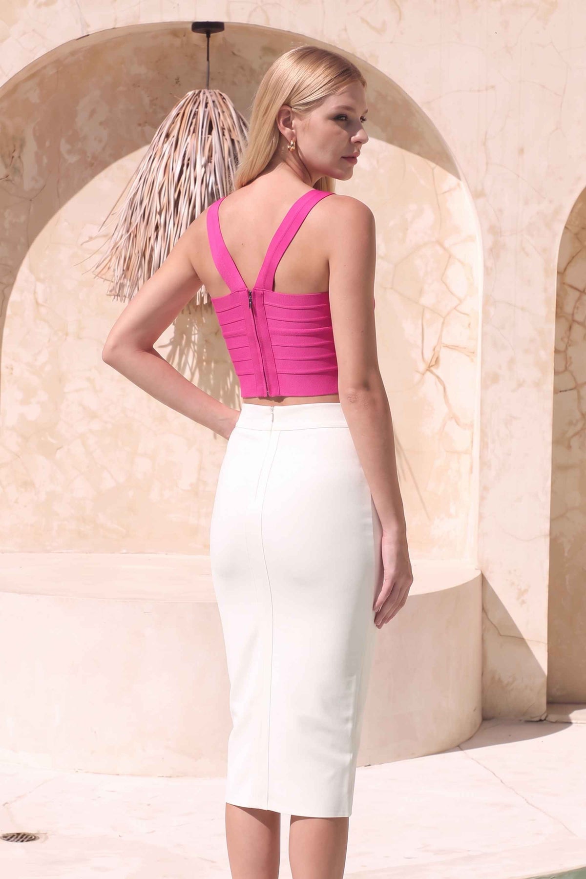 Woman wearing a figure flattering  Jay Bandage Crop Top - Hot Pink BODYCON COLLECTION