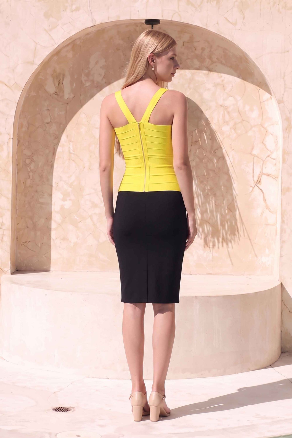 Woman wearing a figure flattering  Jay Bandage Top - Sun Yellow BODYCON COLLECTION