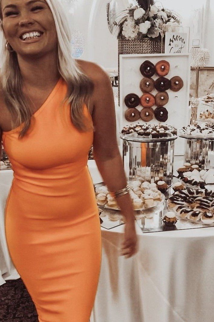 Woman wearing a figure flattering  Joi Bodycon Midi Dress - Apricot Orange Bodycon Collection