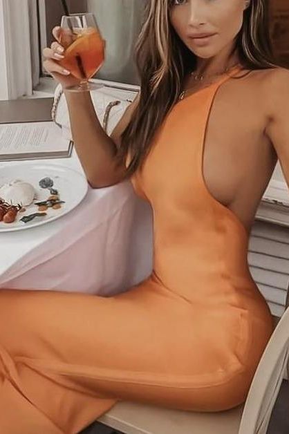 Woman wearing a figure flattering  Joi Bodycon Midi Dress - Peach Bodycon Collection