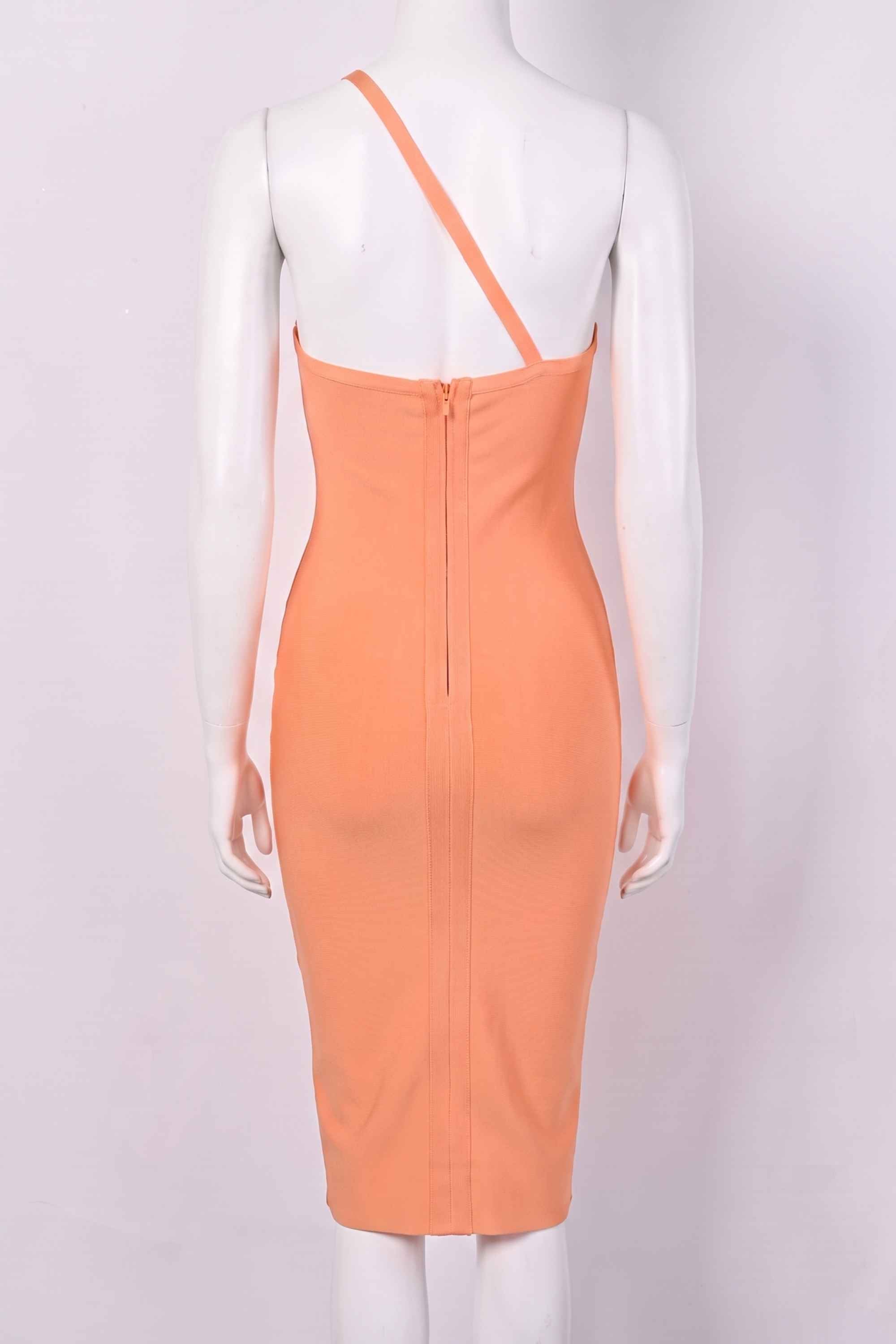 Woman wearing a figure flattering  Joi Bodycon Midi Dress - Peach Bodycon Collection