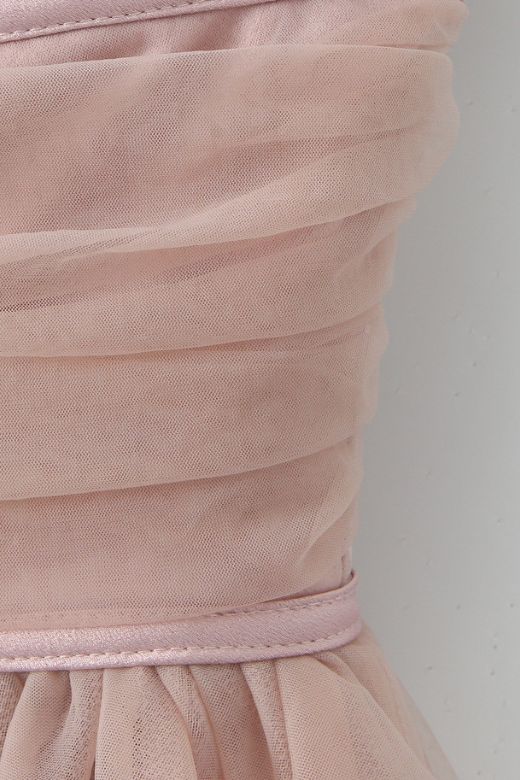 Woman wearing a figure flattering  Kaya Bodycon Mini Wrap Tulle Dress - Oyster Pink BODYCON COLLECTION