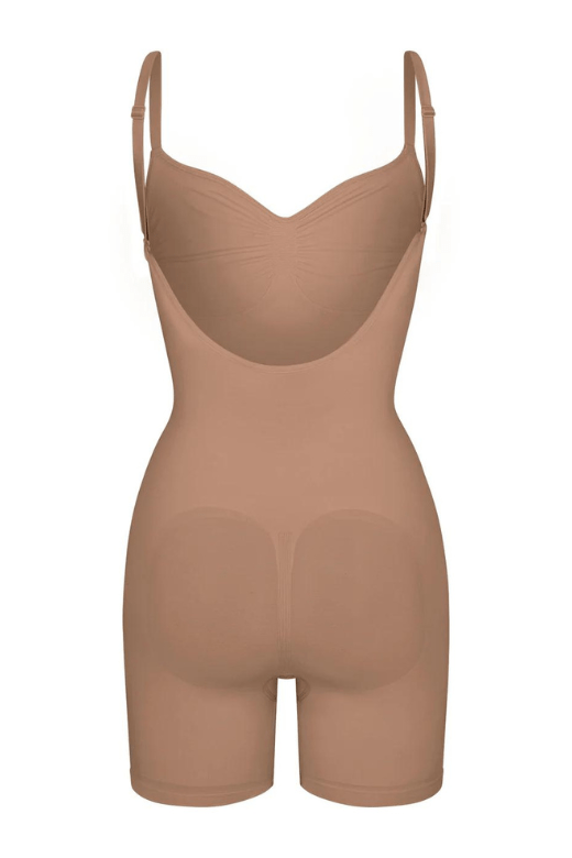 Woman wearing a figure flattering  Low Back One Piece Bodysuit Shapewear - Mid Thigh Bodycon Collection