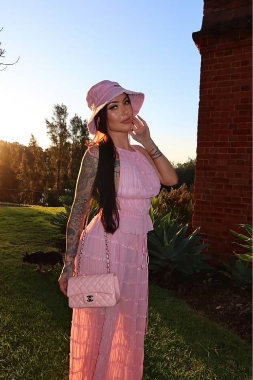 Woman wearing a figure flattering  Meryl Wrap Top and Maxi Skirt Set - Pink Fuzz BODYCON COLLECTION