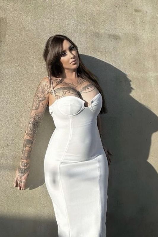 Woman wearing a figure flattering  Mia Bandage Dress - Pearl White BODYCON COLLECTION