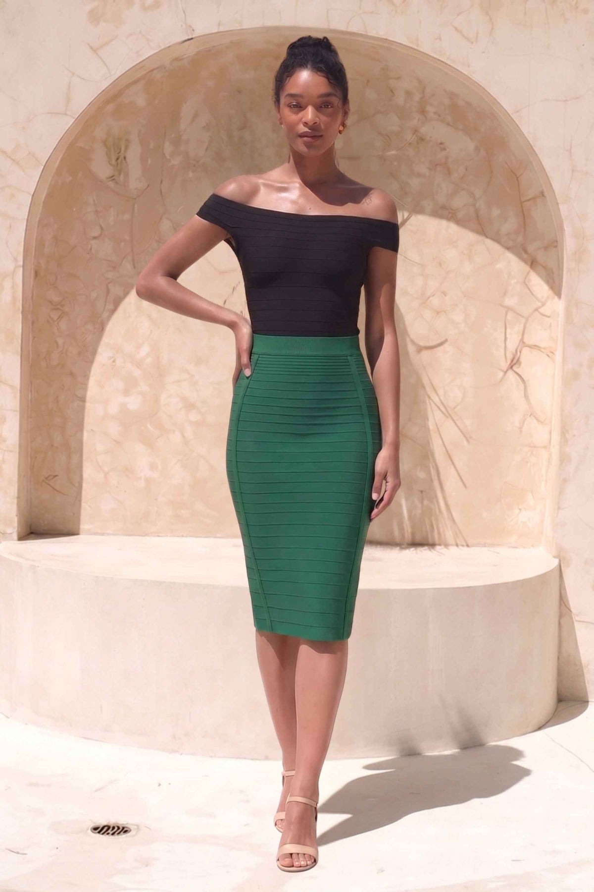 Woman wearing a figure flattering  Pencil High Waist Bandage Knee Length Knitted Skirt - Emerald Green BODYCON COLLECTION