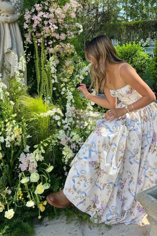 Woman wearing a figure flattering  Tasmin Bodycon Midi Dress - White Floral BODYCON COLLECTION